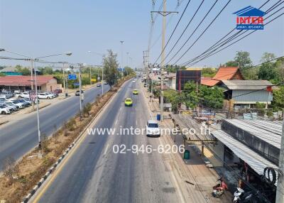 Busy street view in urban area with visible real estate signage