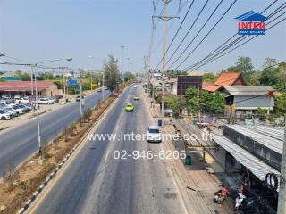 Busy street view in urban area with visible real estate signage