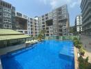 Modern apartment buildings with a large communal swimming pool