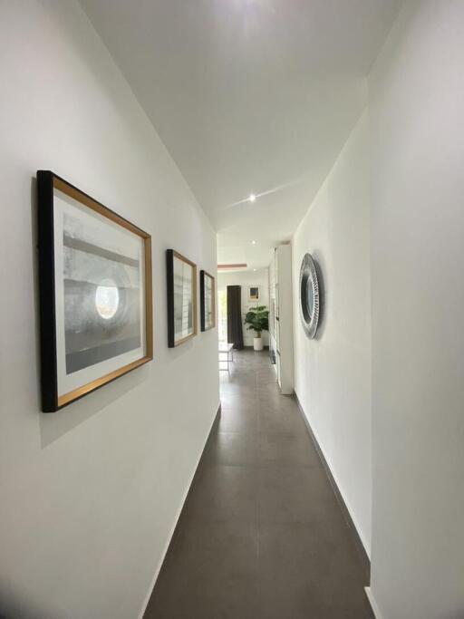 Bright and modern hallway with framed artwork and well-lit ambiance