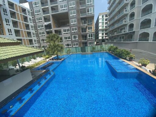 Bright and inviting residential building pool surrounded by modern apartments
