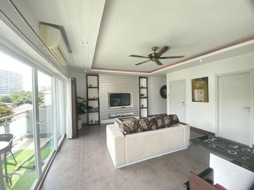 Spacious living room with modern furniture and balcony access