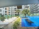 Luxurious pool area with loungers in a modern residential building complex