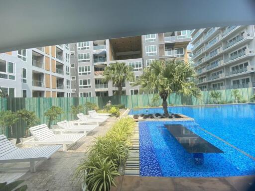 Luxurious pool area with loungers in a modern residential building complex