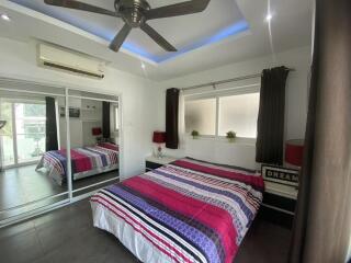 Spacious and well-lit bedroom with modern amenities