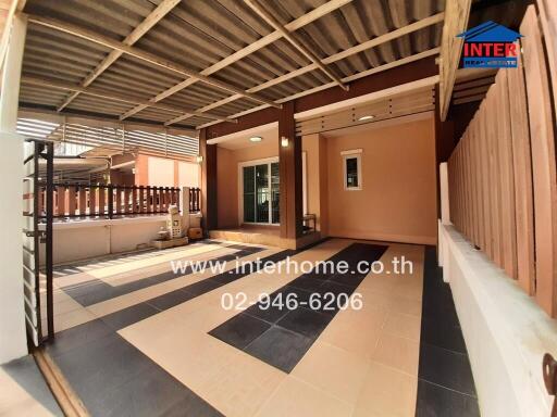 Spacious enclosed patio with checkered flooring and wooden accents