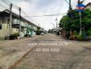 Street view of a residential area with townhouses and clear skies