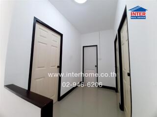 Bright and modern white hallway interior with multiple doors