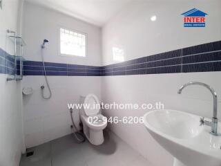 Modern white bathroom with sleek blue tile accents