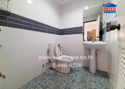 Modern bathroom with blue tiles and white fixtures