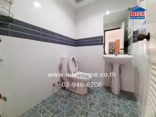 Modern bathroom with blue tiles and white fixtures