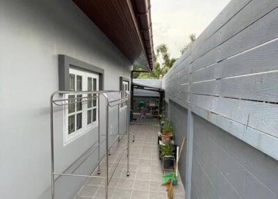 Spacious outdoor passage with grey flooring along the building side
