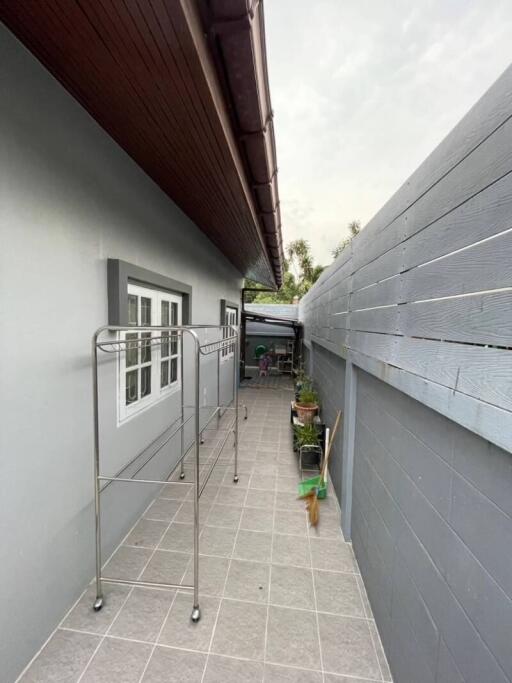 Spacious outdoor passage with grey flooring along the building side