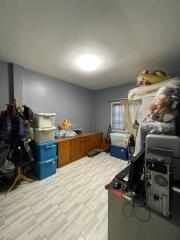 Cluttered bedroom with mixed use storage and light flooring