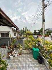 Spacious outdoor patio with potted plants and a paved area