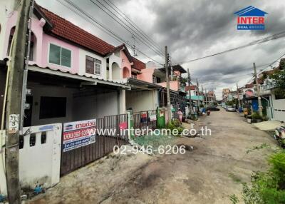 Street view of suburban pink houses with overcast sky