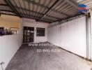 Spacious enclosed garage with metal roof and white walls