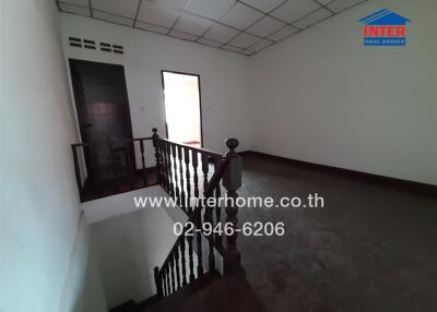 Empty interior space of a building showing staircase and railing