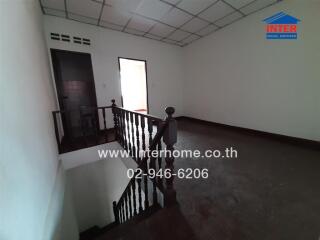 Empty interior space of a building showing staircase and railing