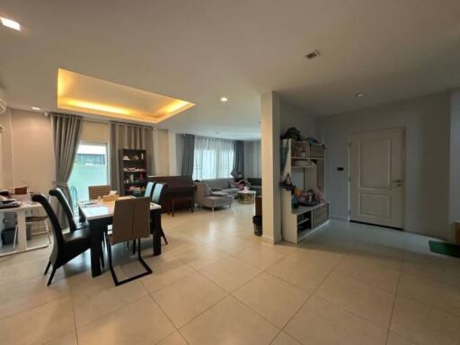 Spacious living room with integrated dining area and modern lighting