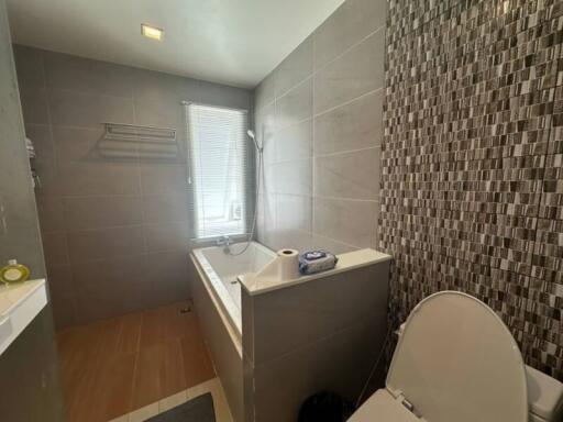 Modern bathroom with decorative tile work and natural lighting