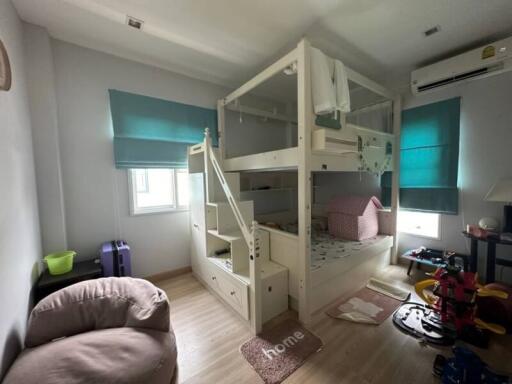 Spacious child-friendly bedroom with large bunk bed and ample natural light