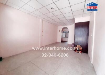 Spacious unfurnished room with large windows and tiled flooring