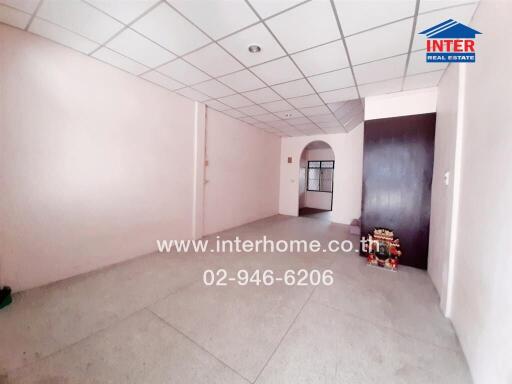 Spacious unfurnished room with large windows and tiled flooring