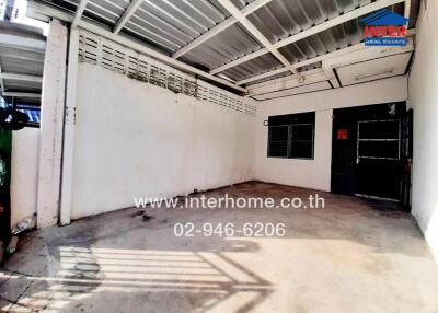 Spacious garage interior with white walls and metal roof