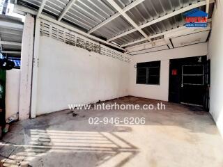 Spacious garage interior with white walls and metal roof