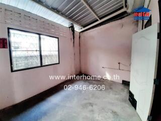 Empty room with large window and industrial ceiling