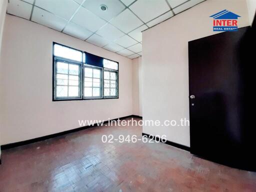 Empty Office Room with Large Windows and Tiled Floor