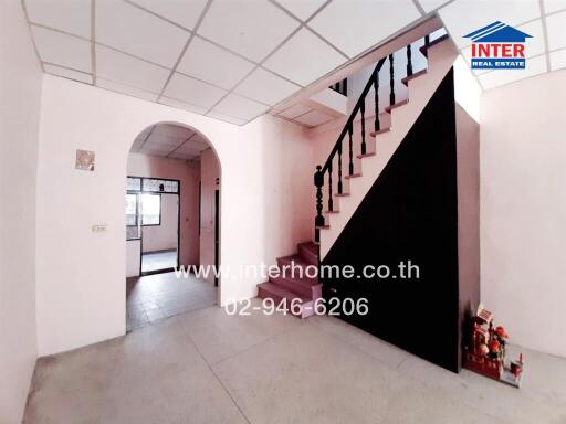 Spacious entryway with staircase and bright interior