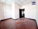 Spacious empty bedroom with red flooring and white walls