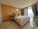 Spacious bedroom with ocean view, featuring a large bed and modern decor