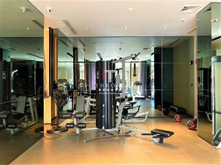 Spacious home gym with modern equipment and large mirrors