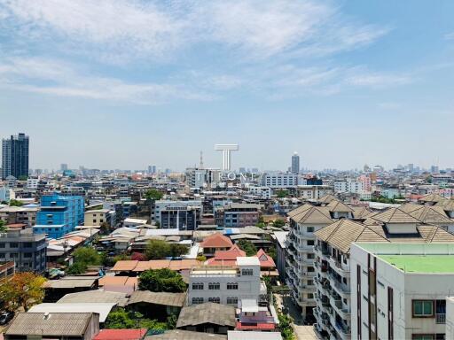Panoramic cityscape view showcasing residential and commercial buildings under clear blue skies