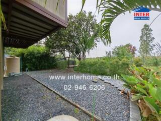 Spacious garden area with lush greenery and a well-maintained pathway