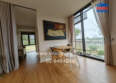 Spacious and bright living room with large windows and outdoor views