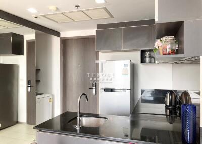 Modern kitchen with stainless steel appliances and wooden cabinets