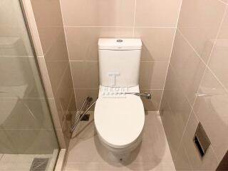 Modern bathroom with well-maintained toilet and wall tiles