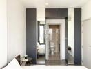 Modern and minimalistic bedroom leading to an ensuite bathroom