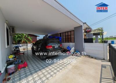 Spacious covered garage with tiled floor and parked car