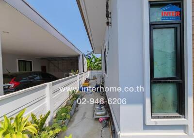 Exterior view of a home with balcony and carport