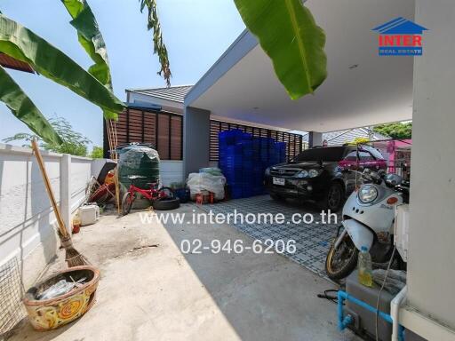 Spacious covered garage with vehicles and storage