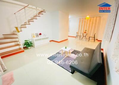 Spacious living room with staircase and dining area