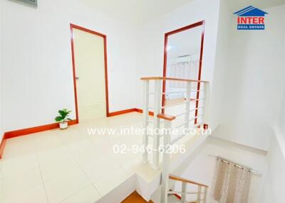 Bright and clean interior staircase with white and red accents