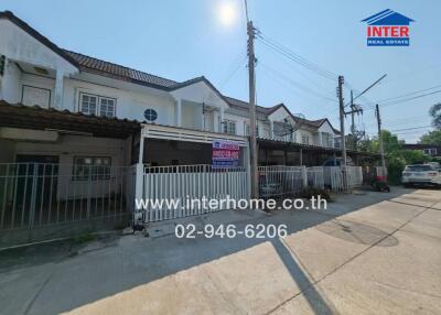 Exterior view of townhouses with for sale sign