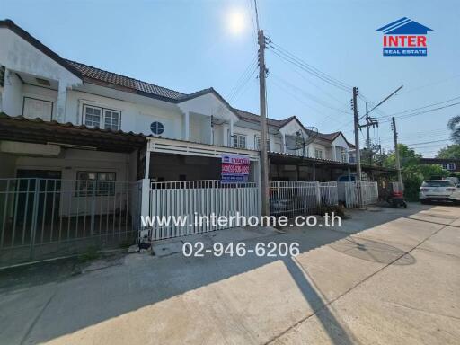 Exterior view of townhouses with for sale sign