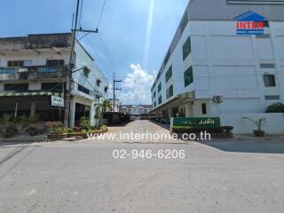 Exterior view of a modern residential building complex under clear blue skies